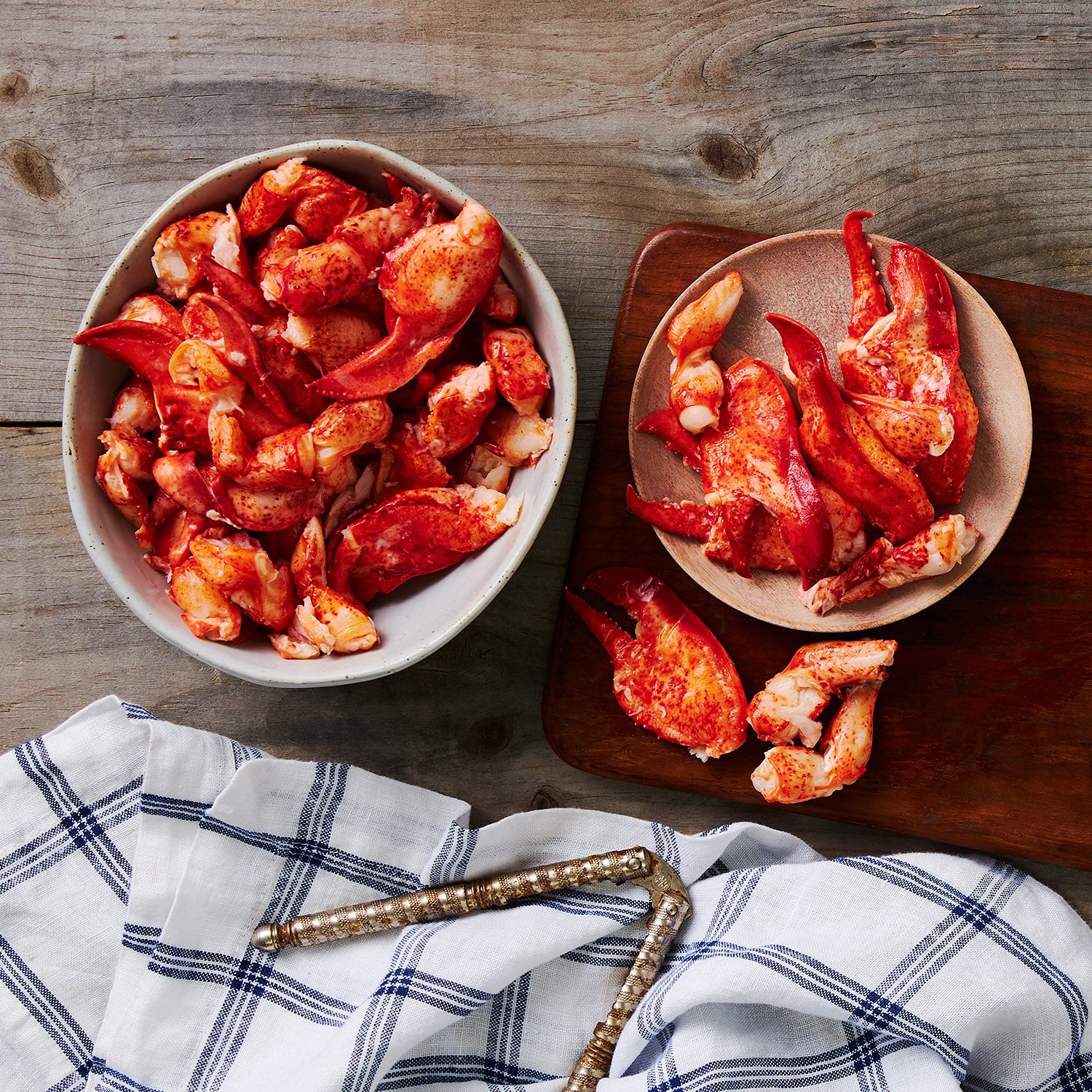  This image shows a Bowl, plate and wooden cutting board, teeming full of mouthwatering Claw and knuckle meat