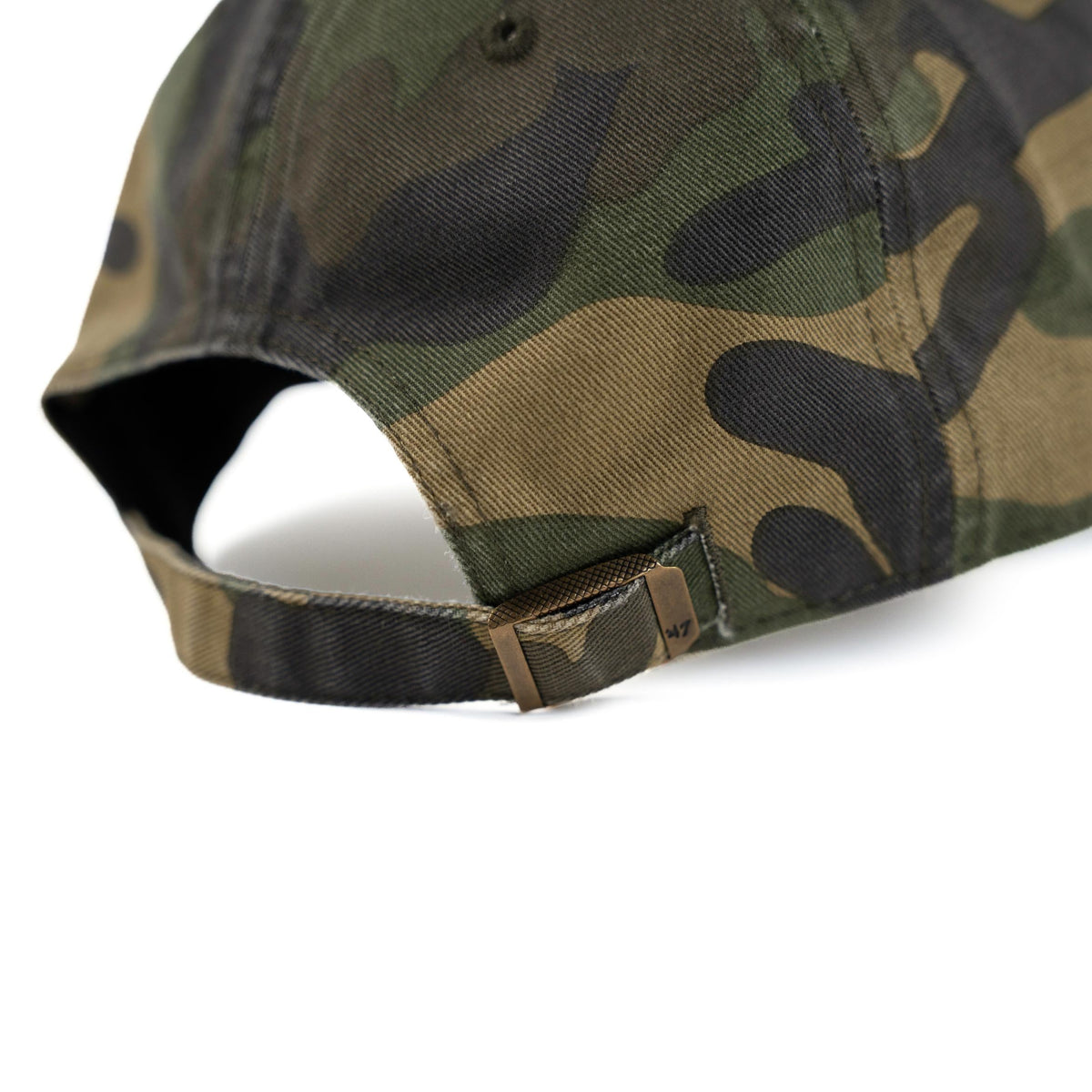 Close-up of green camo dad hat adjustable strap with antique brass slide buckle closure