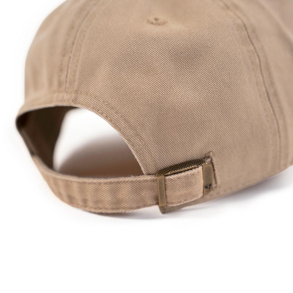 Close-up of the khaki dad hat's adjustable metal buckle strap with a 47 brand mark