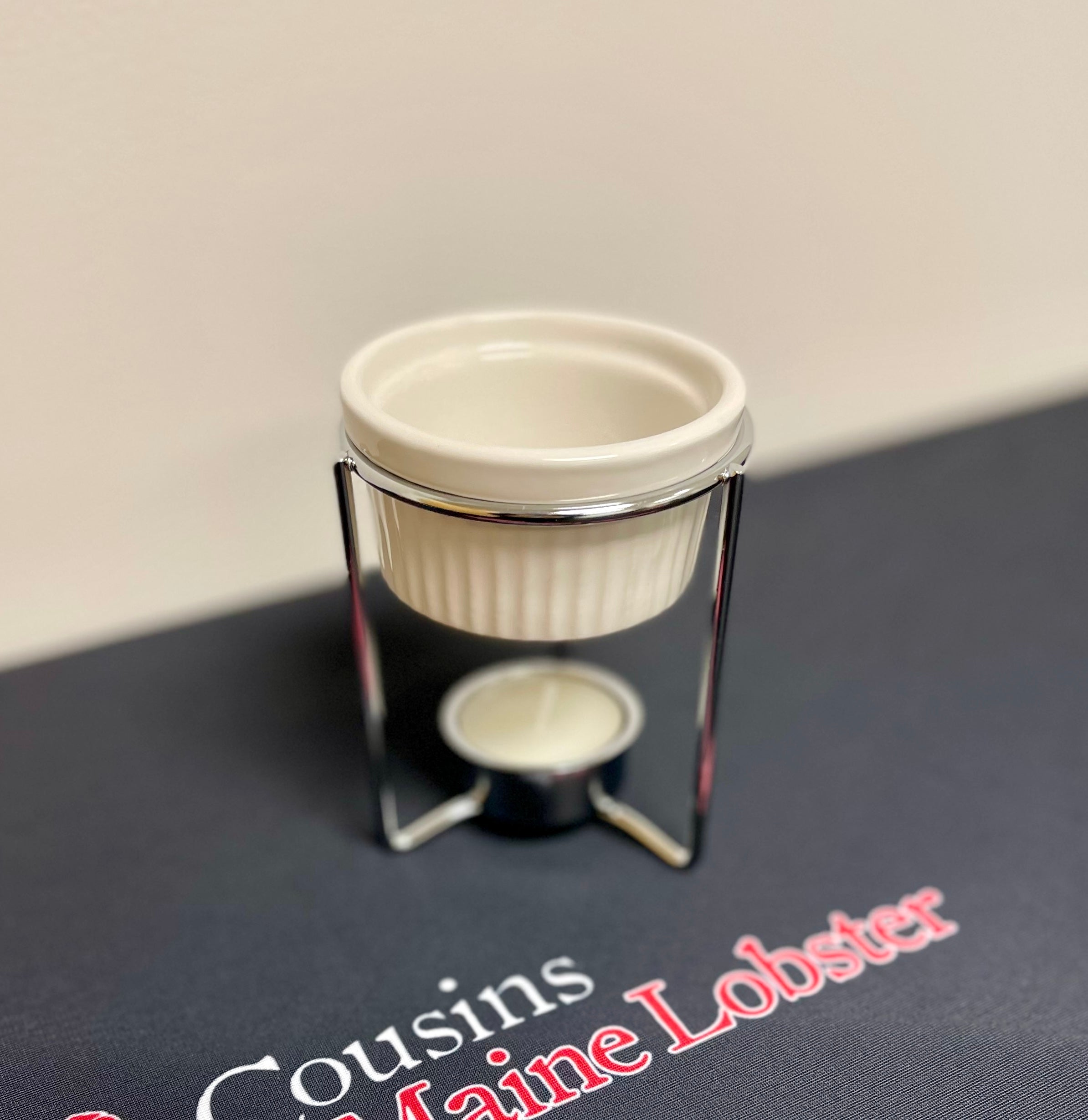 This photo shows the butter warmer which is used to keep your butter perfectly melted to be dipped in and enjoyed with your favorite meal from Cousins Maine Lobster