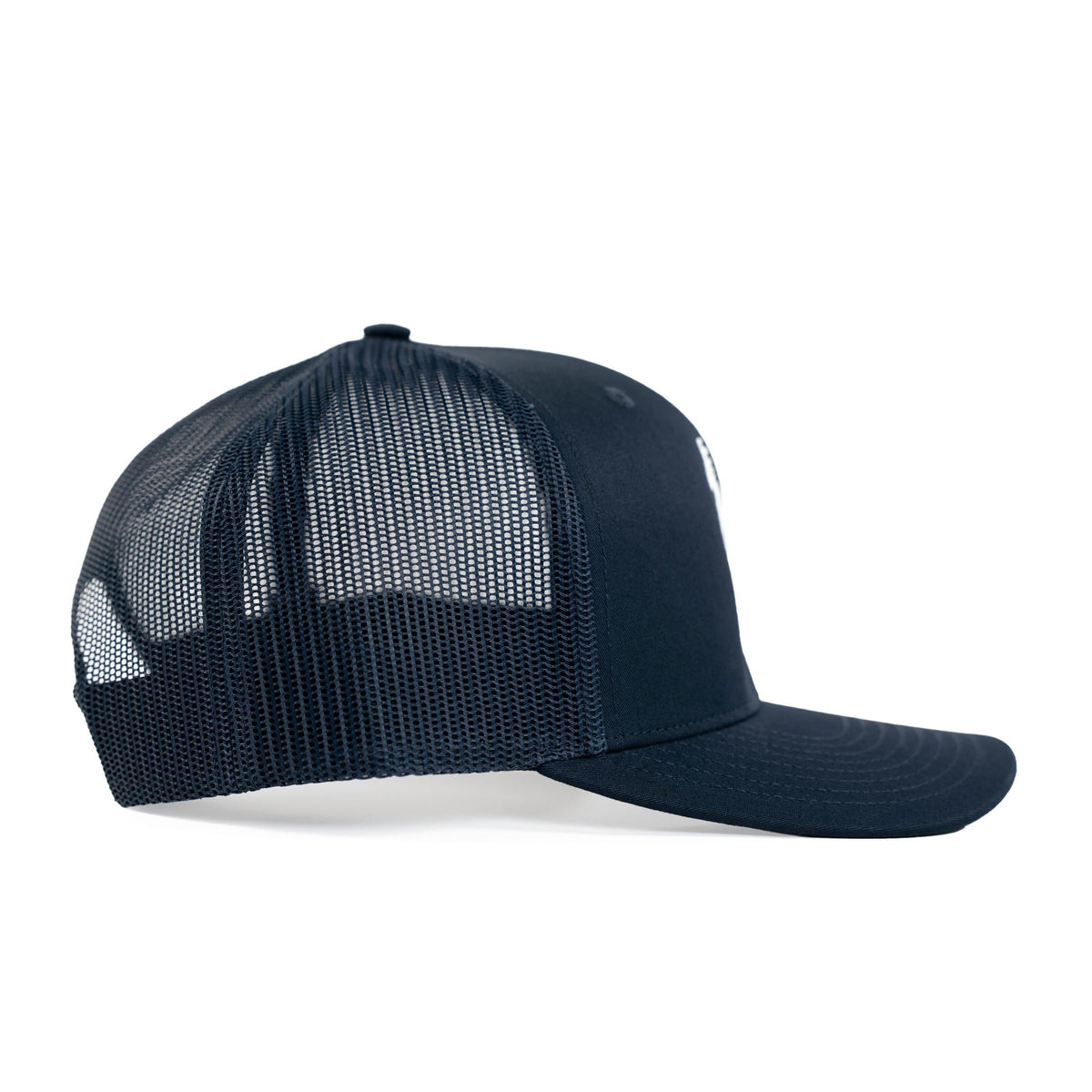 Side view of navy trucker hat with mesh back and white embroidered logo on front