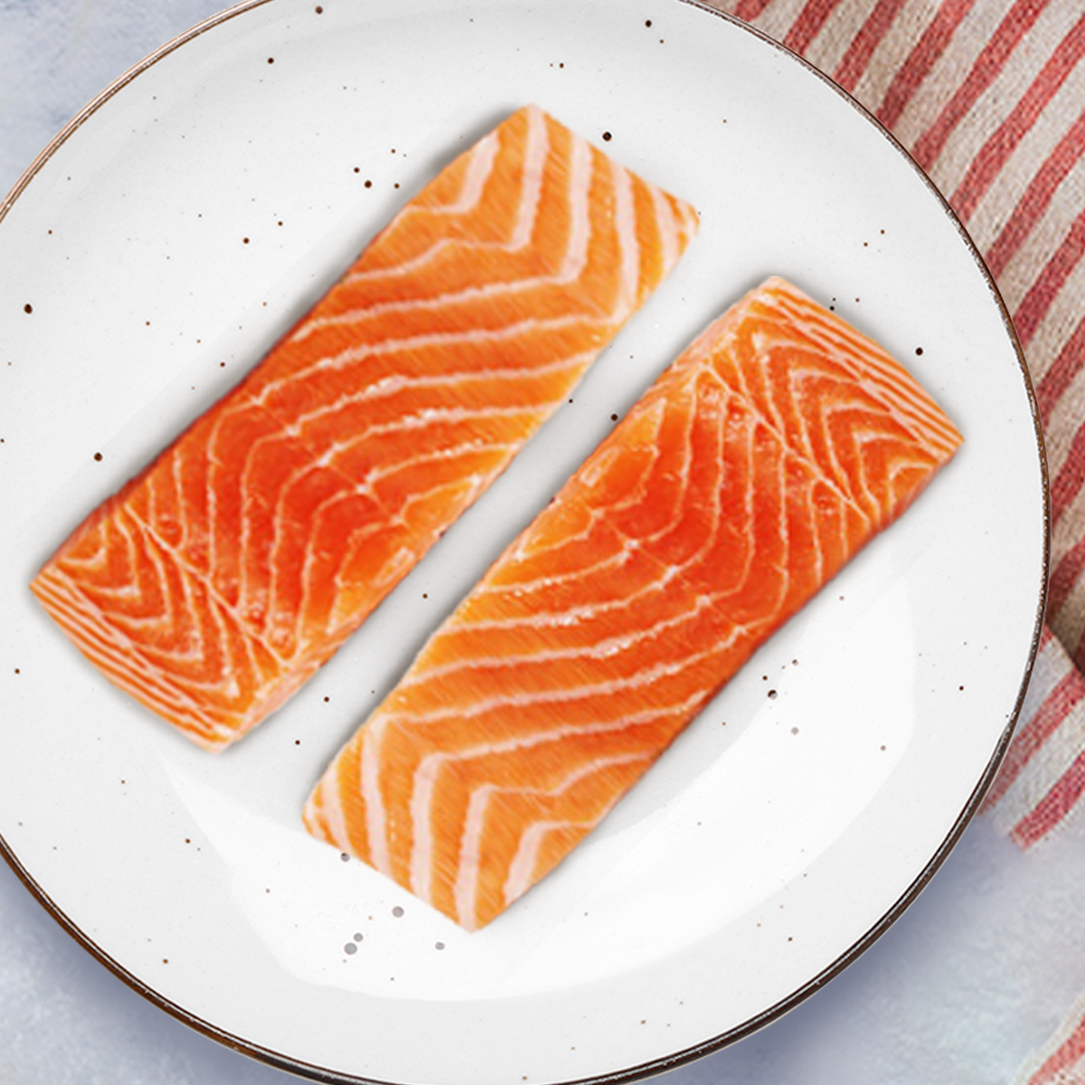 This image shows 2 8oz Atlantic Salmon Filets plated and ready to be prepared however you may choose